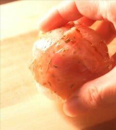 早朝から子どもにお弁当を作る50代の母。ベーコンでくるりと巻いたおにぎりをお弁当箱に組み込んだ献立の工夫と仕上がり