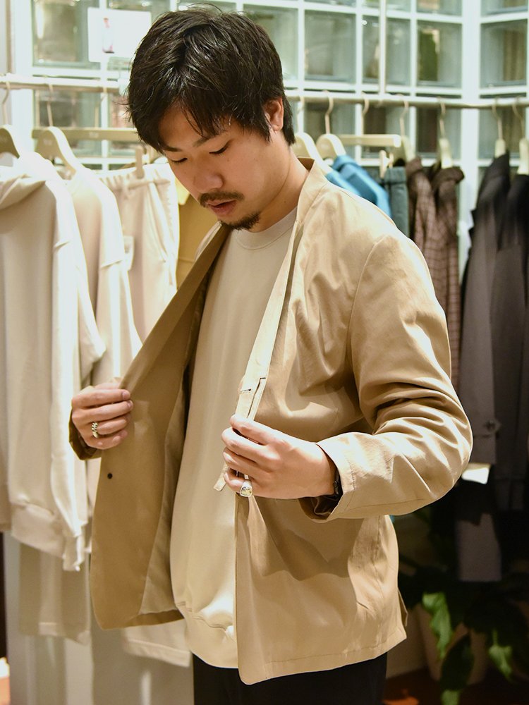 フロントは比翼仕立てで、ボタンでも止められる。ノーカラーなのでカーディガン感覚で使えるジャケット