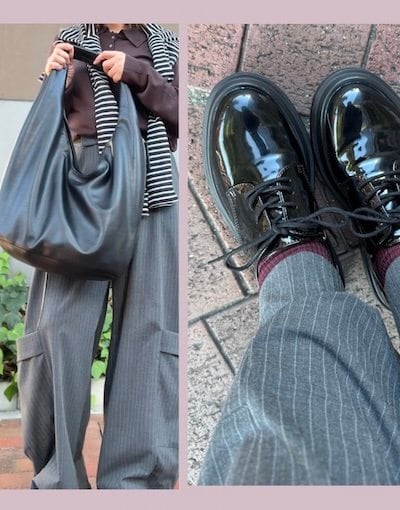 肩にかけたボーダーのカーディガンと黒いバッグ