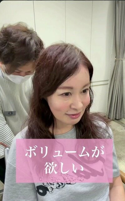胸の下までの長さで、ゆるやかなウェーブのある、ブラウンの髪の女性（ビフォー）
