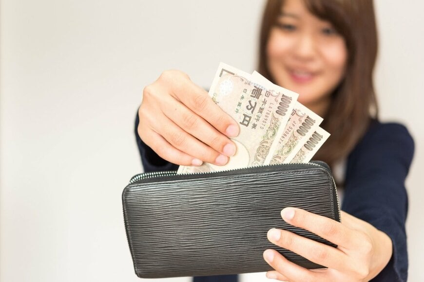 財布からお金を出す写真